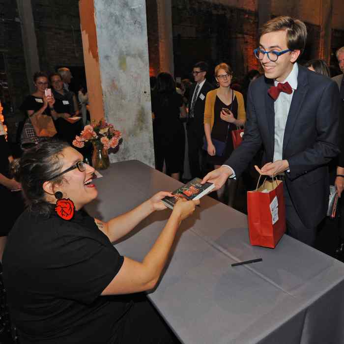 Carmen Maria Machado signing a book at the 2017 Graywolf Literary Salon