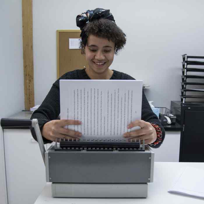 Graywolf staffer Yana Makuwa binding a manuscript