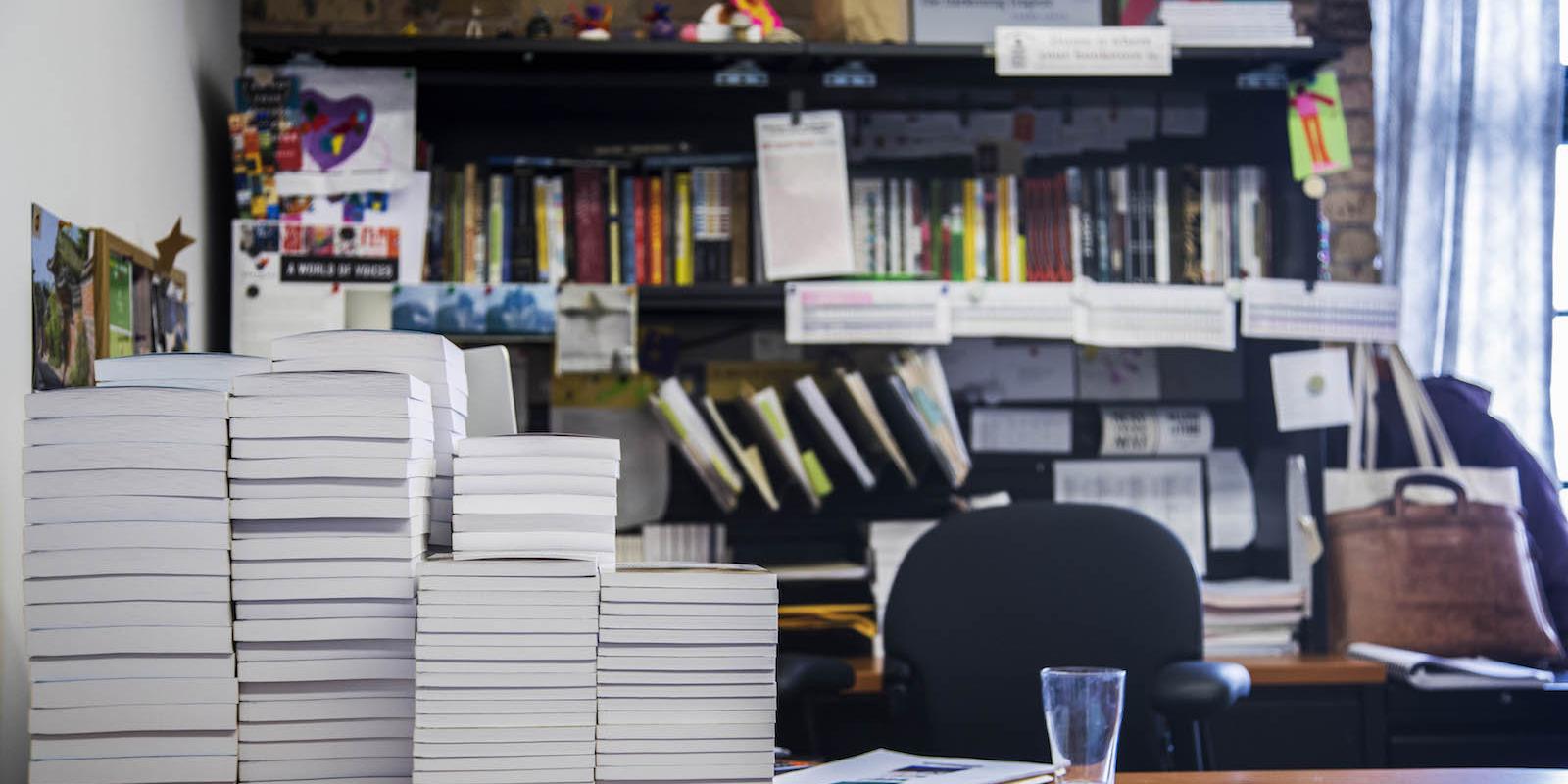 Graywolf desk with stacked books