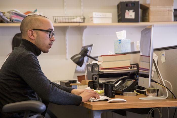Inaugural Citizen Literary Fellow Chantz Erolin at his desk