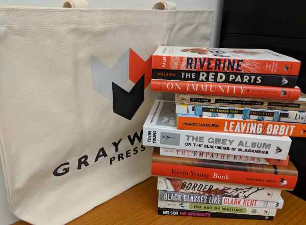 Graywolf Press tote bag and stack of books