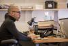 Chantz Erolin at his desk Thumbnail